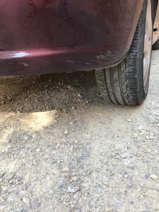 Dusty Car With Scrape Damage In The Rear