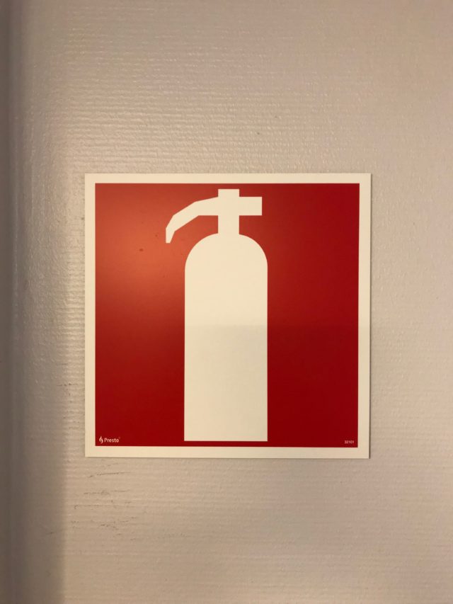 Fire Extinguisher Sign Mounted On A Wall