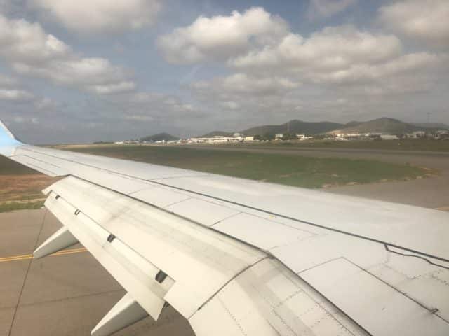 Voew Of Wing Of A Plane Landing Or Taking Off On Runway