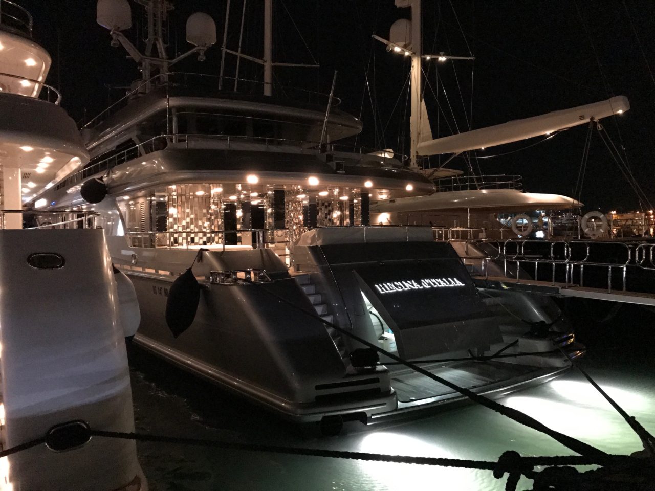 Luxury Yacht Docked At Harbor With Lights