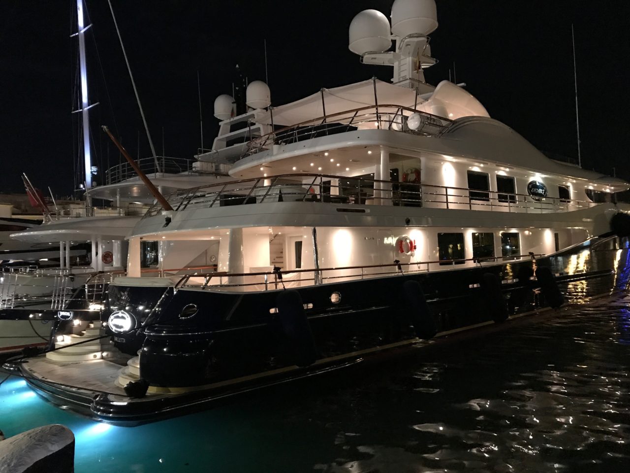 Expensive Luxury Yacht With Lit Lights In Harbor
