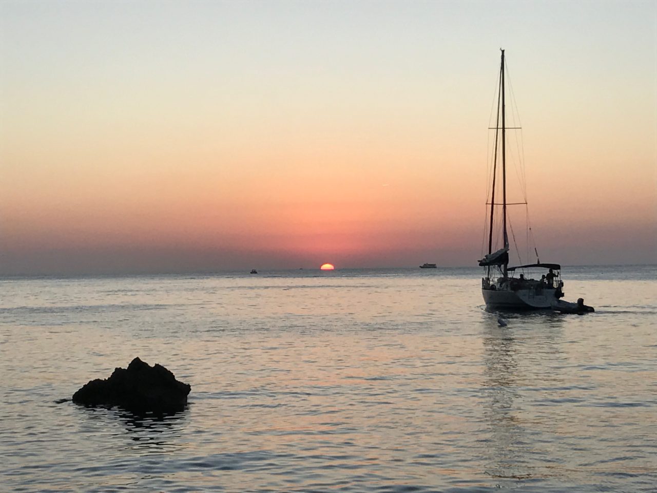 Sailing Boat In Front Of Ocean Horizon Sunset