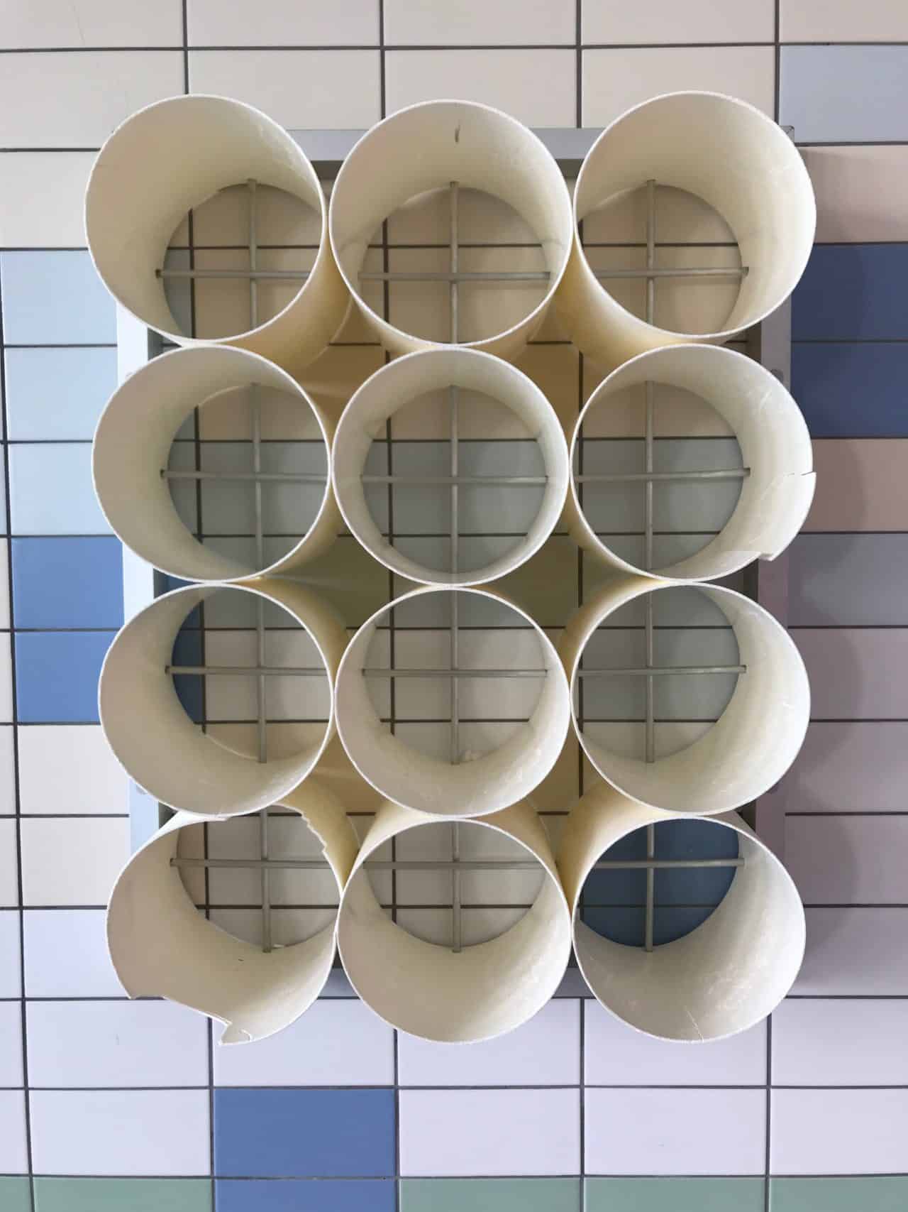 Storage Pipes Mounted On Tiled Wall