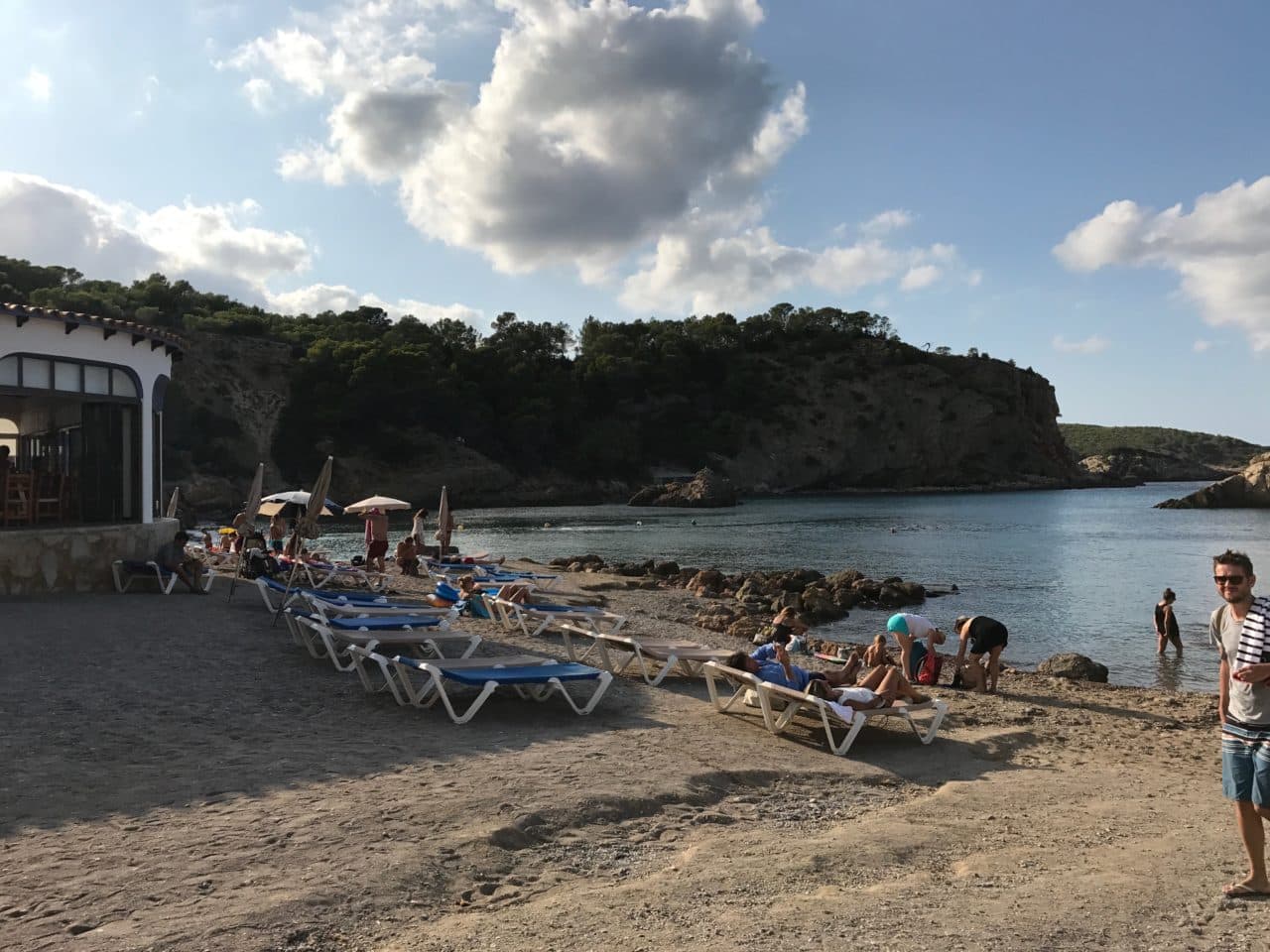 Sunbeds On A Gravel Beach With People