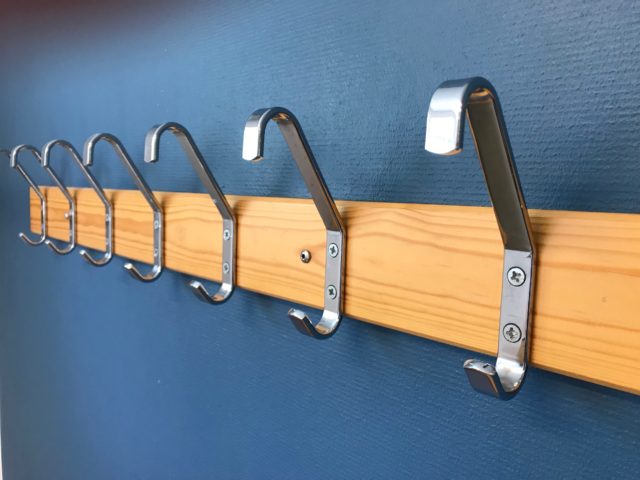 Chrome Clothes Hangers On Blue Wall