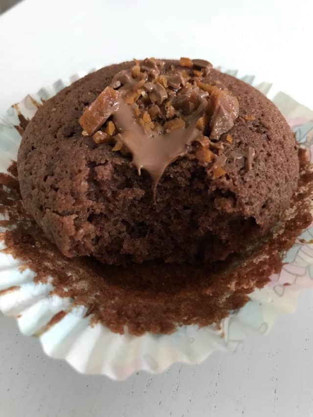 Melted Chocolate On A Cupcake In White Paper Form On A White Table