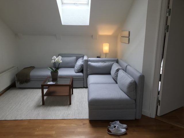 Bright Lounge With Skylight Window And Shoes On The Floor