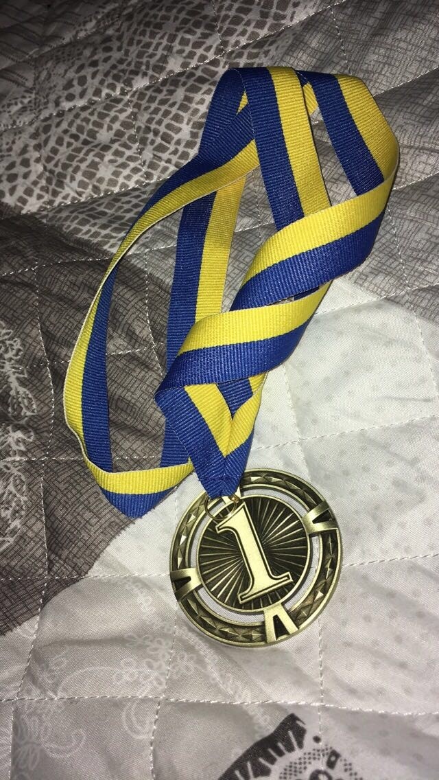First Place Gold Medal Laying On Blanket
