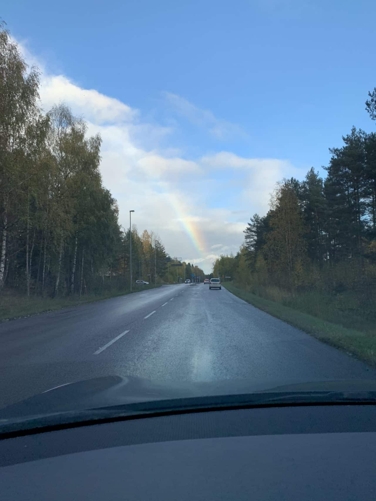 Driving Car After Rain With A Rainbow