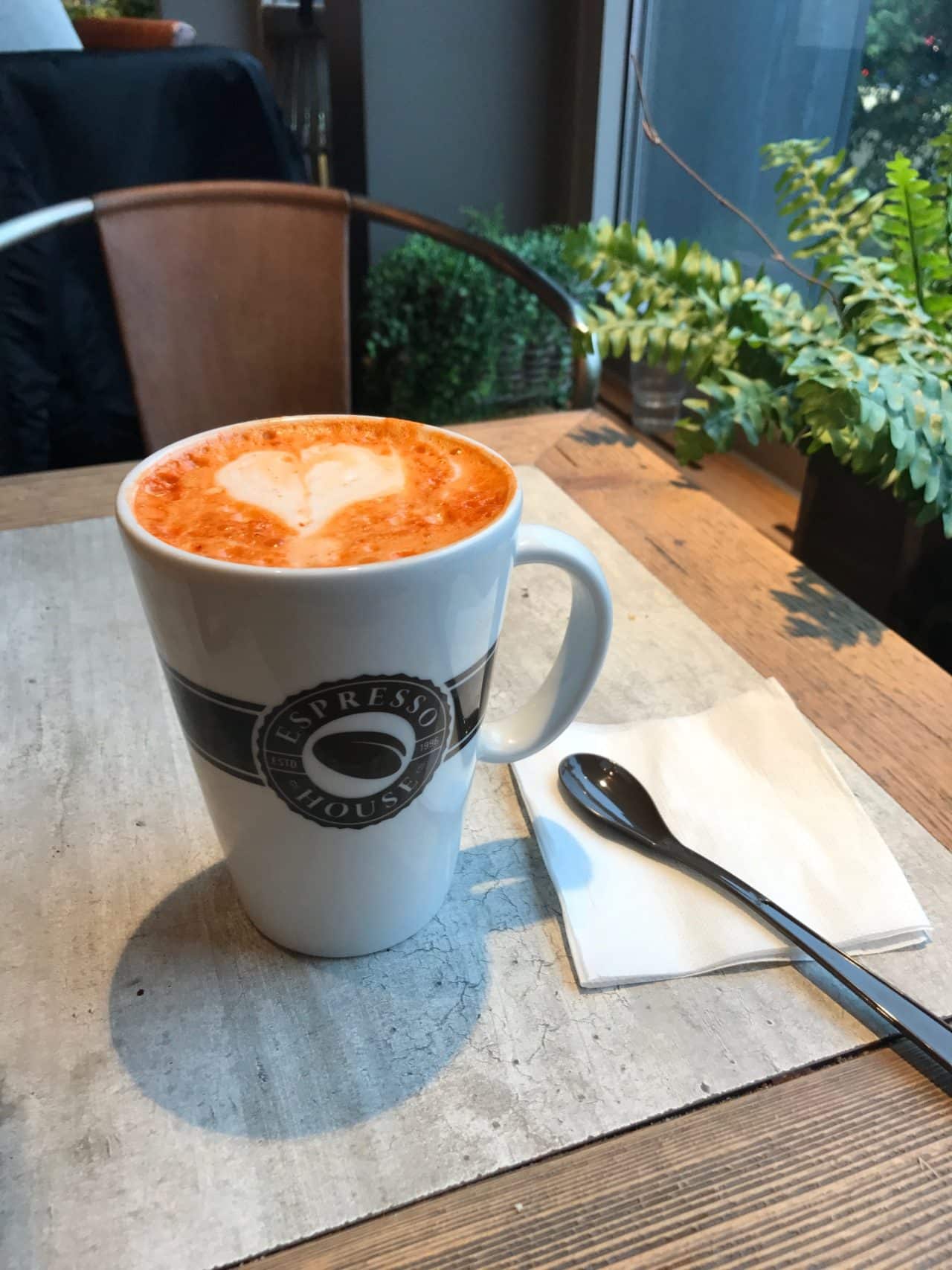 A Cup Of Coffee Latte With A Spoon And A Heart