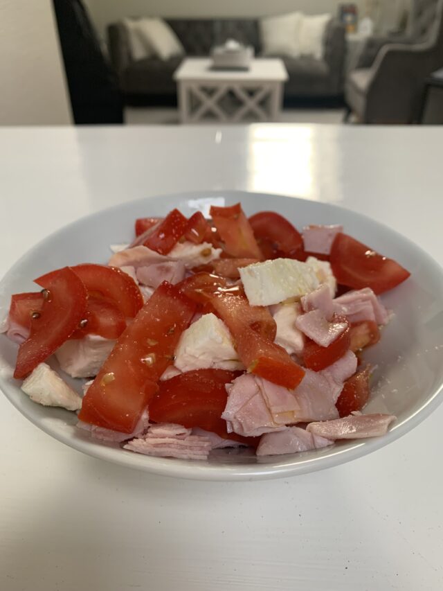 Bowl Of Mozzarella Tomato And Ham With Olive Oil