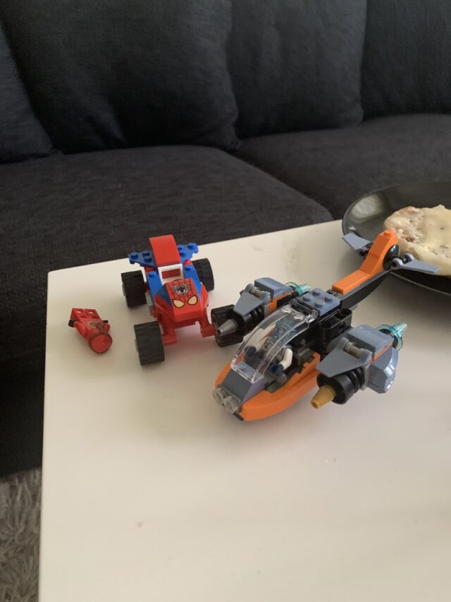 Lego Car And Plane With Figurines On A Livingroom Table