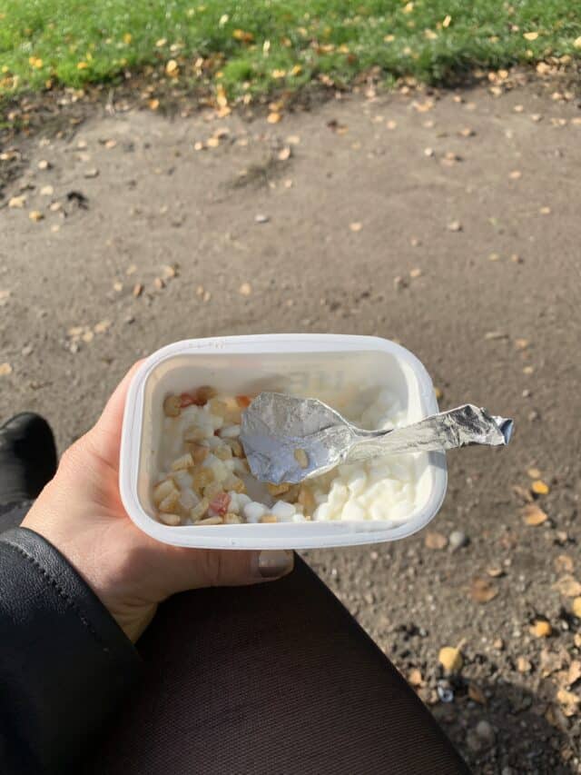 Woman Holding Cottage Cheese With Nuts Lunch And Makeshift Spoon