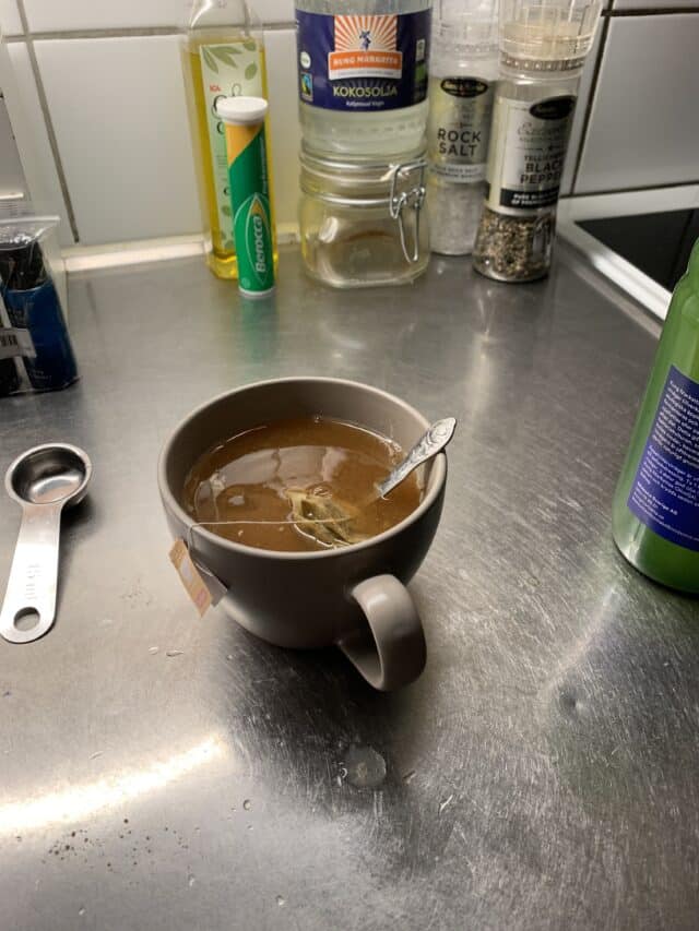 Cup Of Tea On Kitchen Counter With Spices