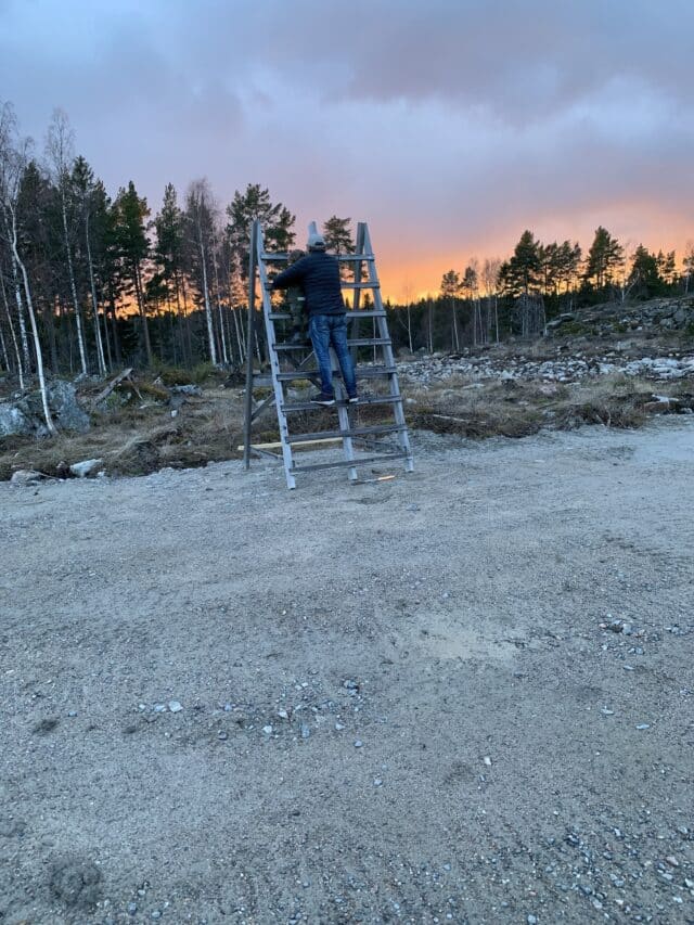 People On A Lookout Ladder Watching The Sunset