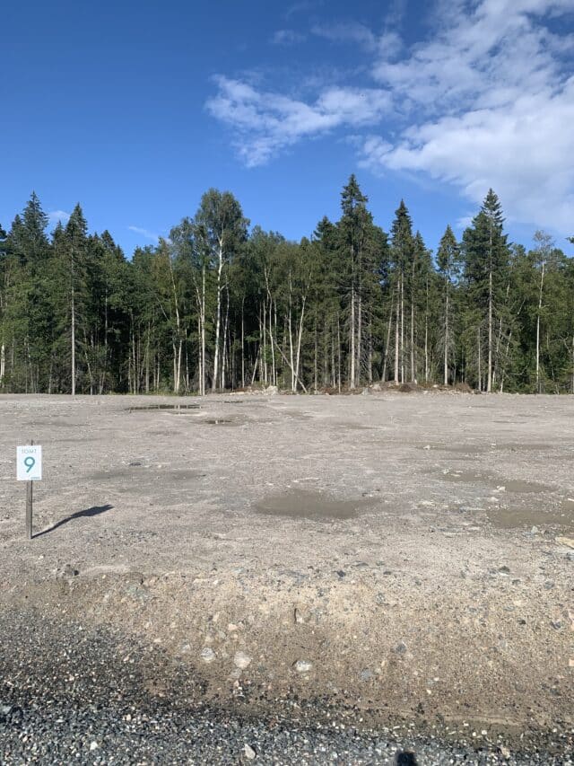 Undeveloped Dirt Land Plot In Front Of Forest