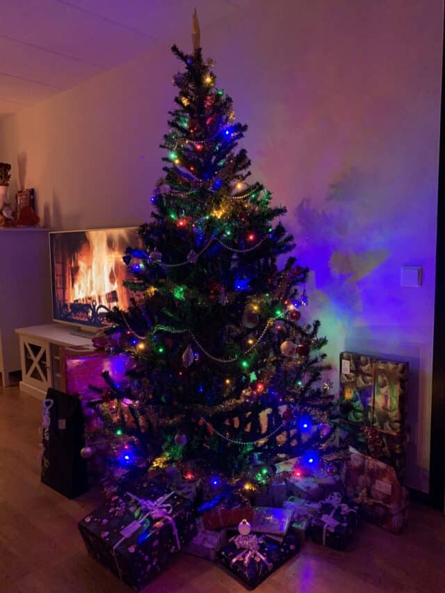 Green Christmas Tree With Presents And Fireplace On TV