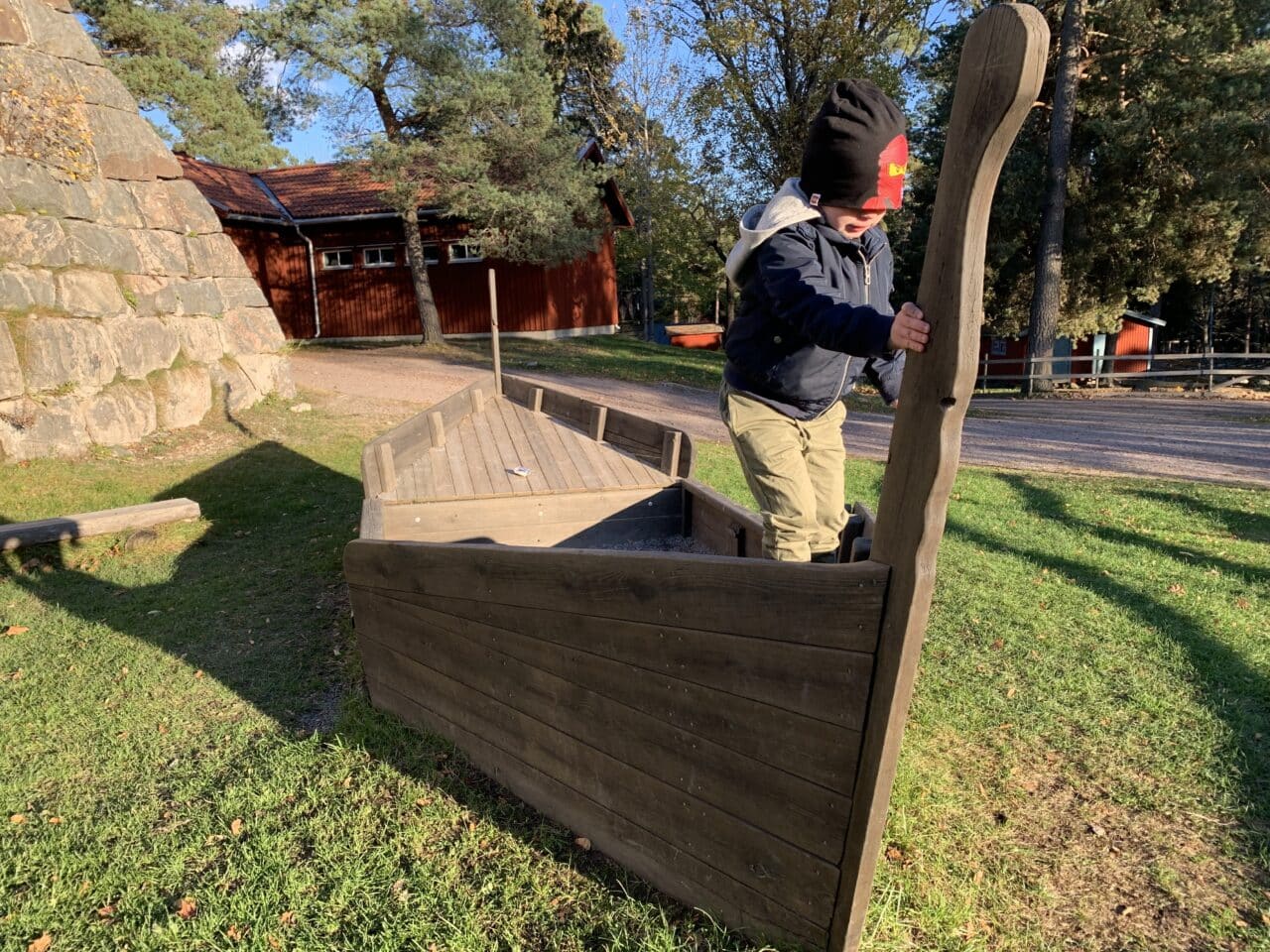 Child Playing On A Wooden Viking Ship In A Playground