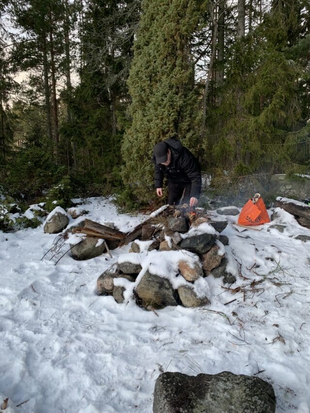Man Preparing Camp Fire In Wilderness Fireplace