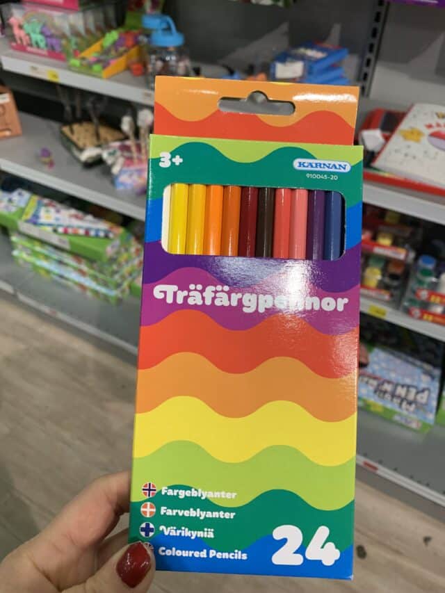 Hand Holding Pack Of Color Pencils In Store