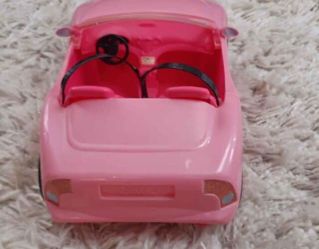 Pink Cabrole Barbie Toy Car On White Carpet