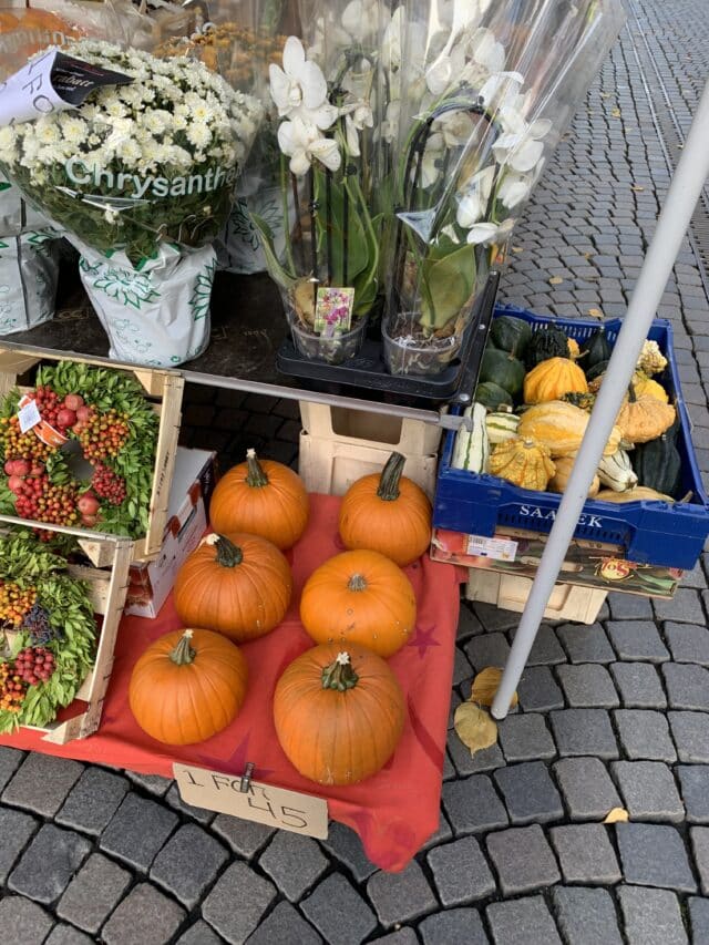 Public Market On City Square Selling Pumpkins And Flowers