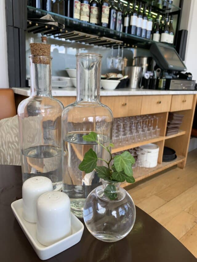 Restaurant Table With Glass Bottles And Salt And Pepper Shakers