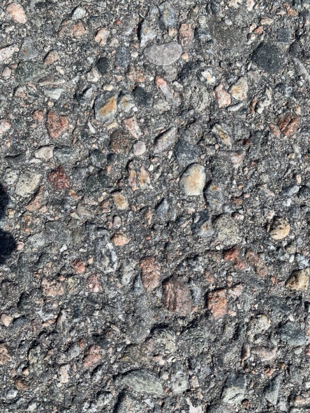 Pebbles And Rocks Embedded In Asphalt Texture Pattern
