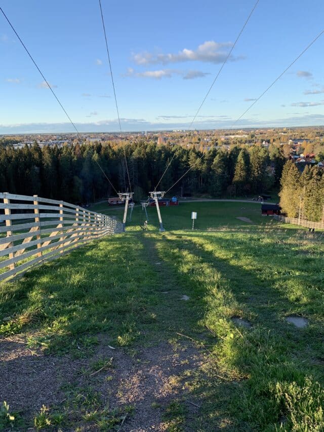 Ski Slope View With Green Grass By The Lift