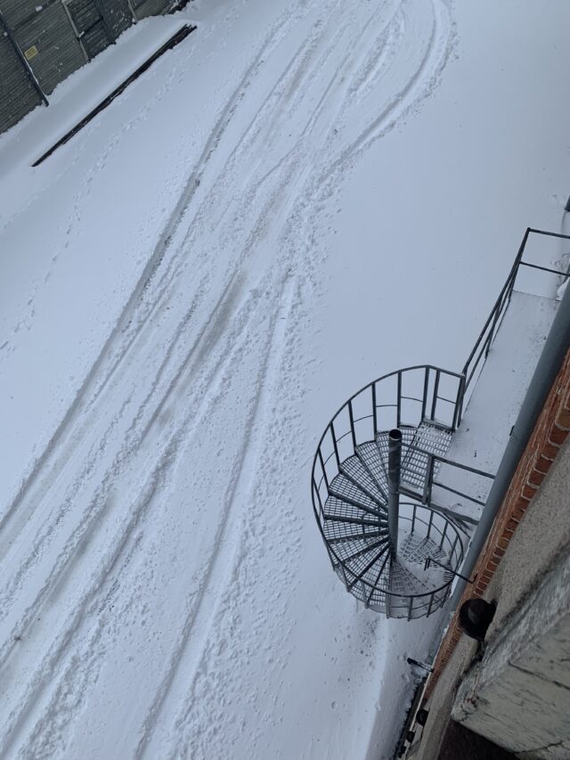Spiral Staircase With Tracks In The Snow At Winter