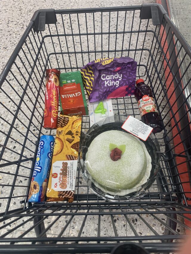 Shopping Cart With Cookies And Cake In Store