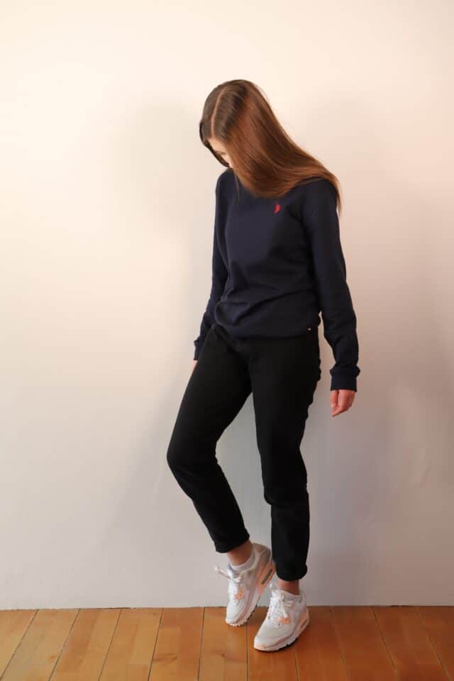 Girl With Brown Hair Looking At The Floor In Dark Clothes