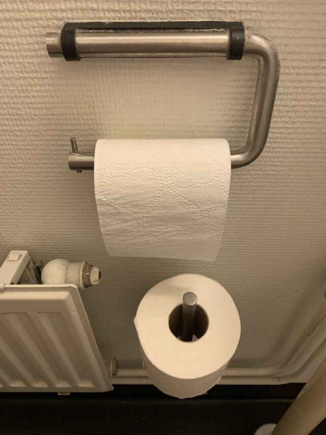 Toilet Hanger And Toilet Paper Rolls By Radiator