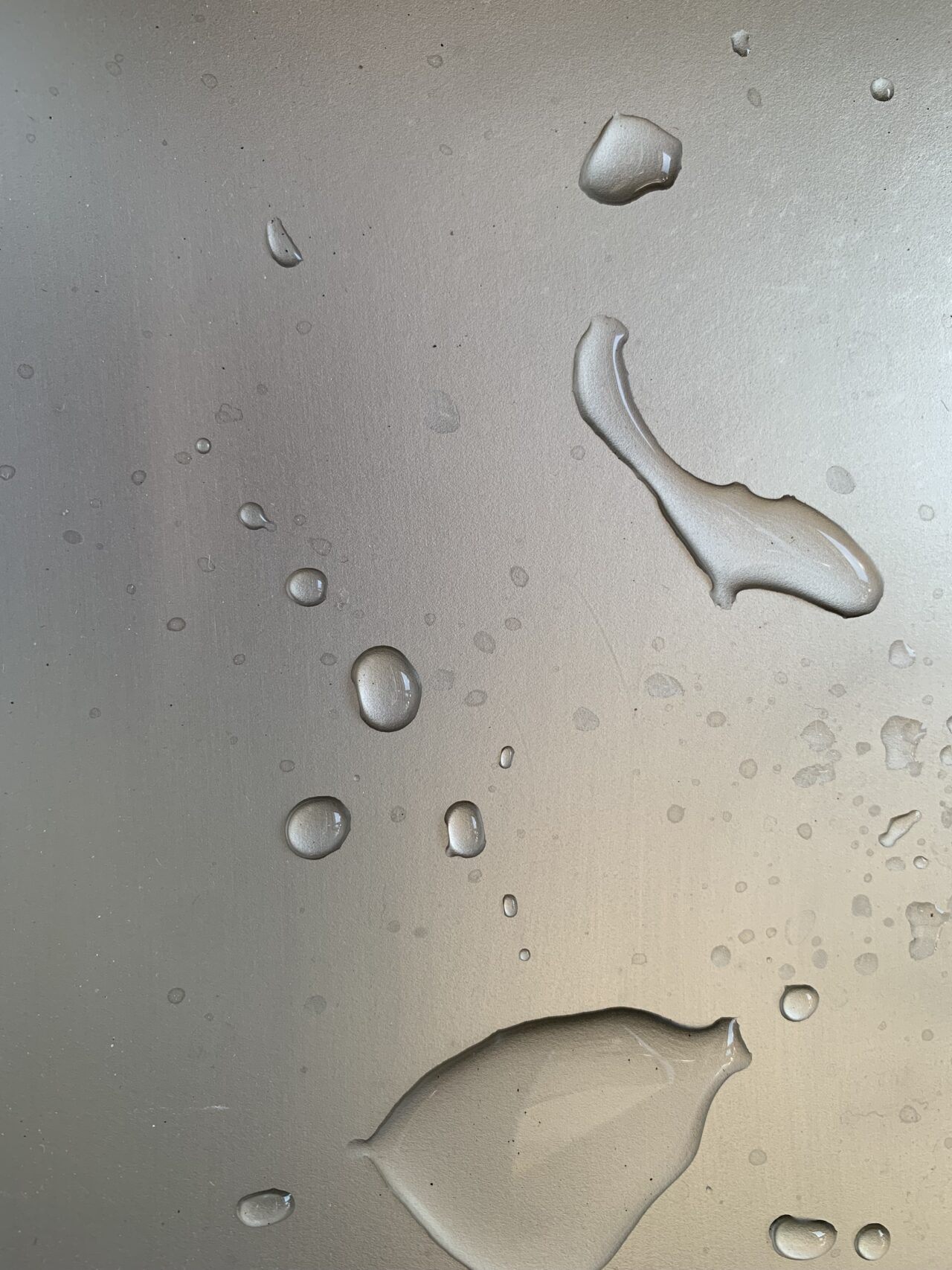 Spilled Water Drops On Metal Surface