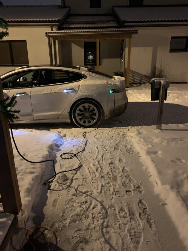 White Tesla Model S Charging At Night In Winter