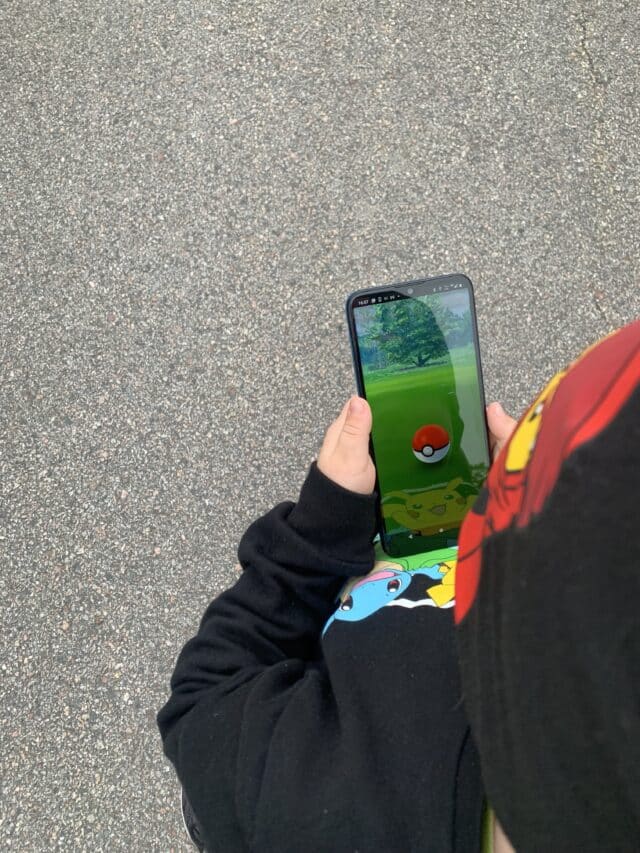Child Using Motorola Phone Playing Pokemon Go Game